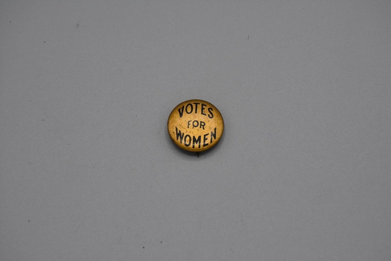 round, gold button with text "Votes for Women" round, gold button with text "Votes for Women"