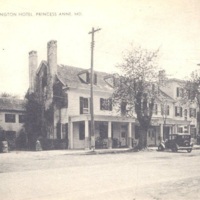 Washington Hotel in Princess Anne, sepia image of three story building with porch, forground is a dirt lane